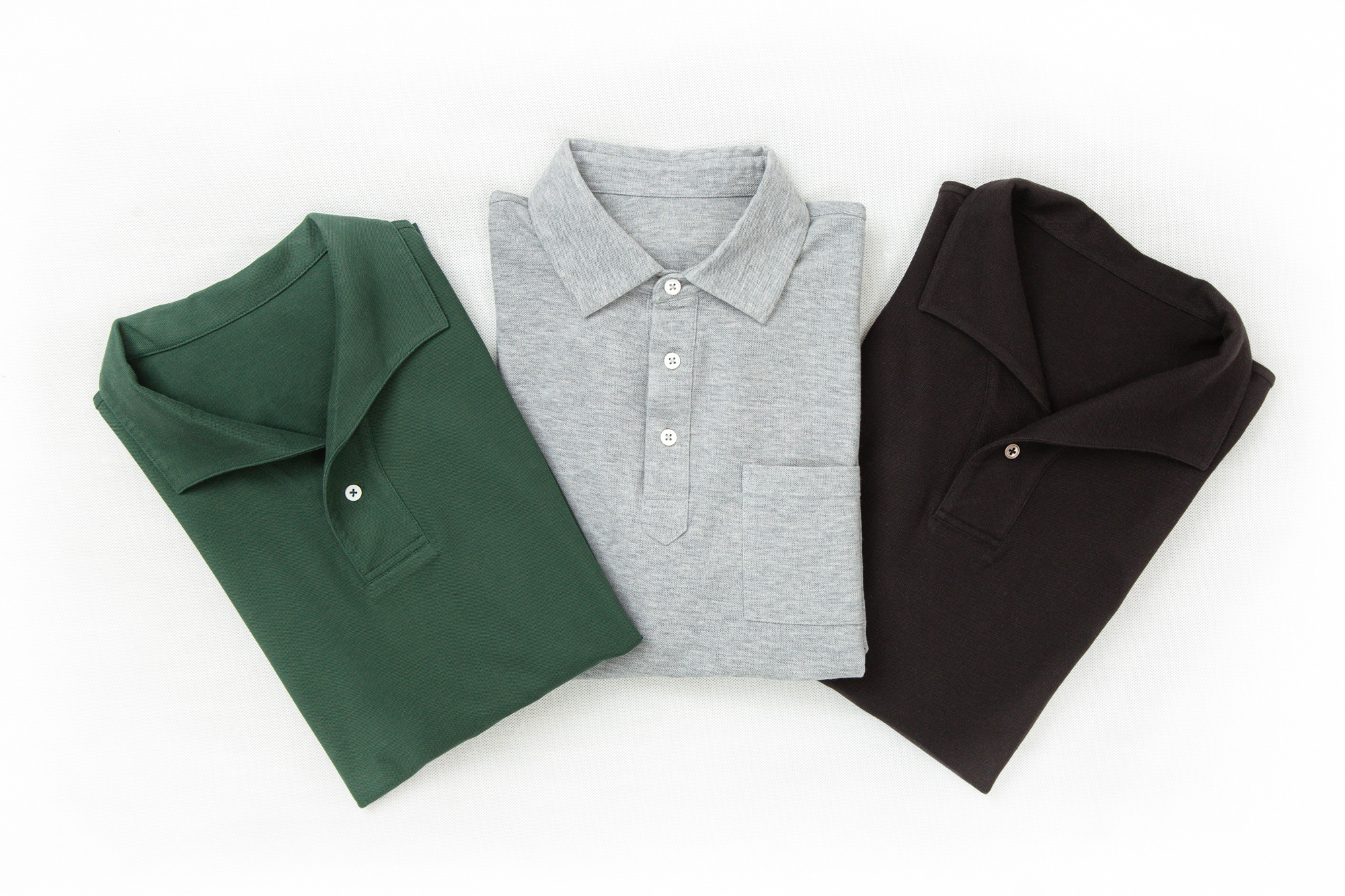 Flat lays of Senszio custom made polo shirts, in green, grey and black. Made from premium Italian stretch cotton
