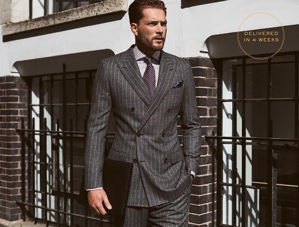 Man in pinstripe smart suit, custom made by Senszio and available for worldwide delivery within 4 weeks